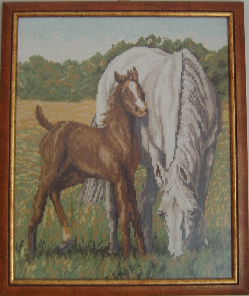 Cross-stitch horses in field
